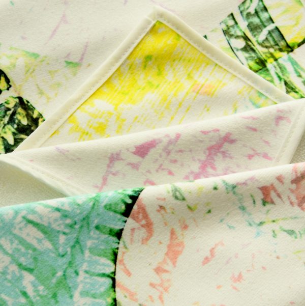 close up of Kirsteen Stewart "Fern" designer towel, in an abstract botanical pattern of yellow, blue and green