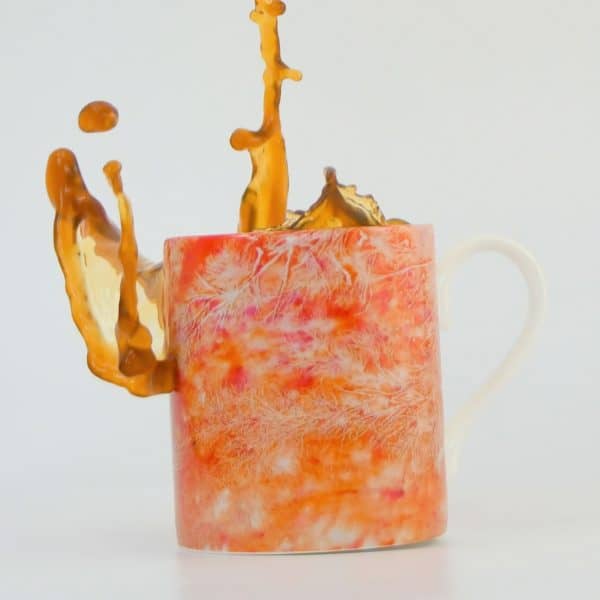 KS Orange Orbit mug with tea splash